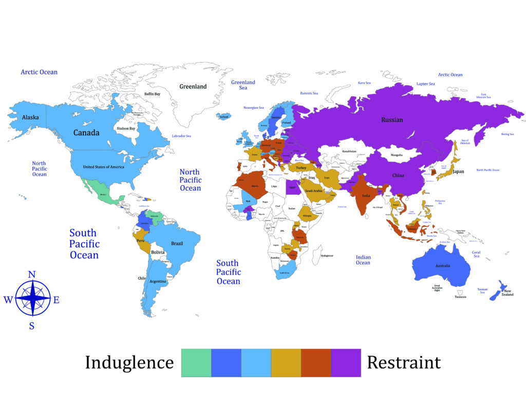A world map is shaded to show indulgence scores.High indulgence (light, bright colors): Latin America, North America, parts of Western Europe — cultures emphasizing personal enjoyment, leisure, and free expression. High restraint (darker colors): East Asia, Eastern Europe, Middle East — cultures prioritizing self-control, strict social norms, and duty over personal gratification.